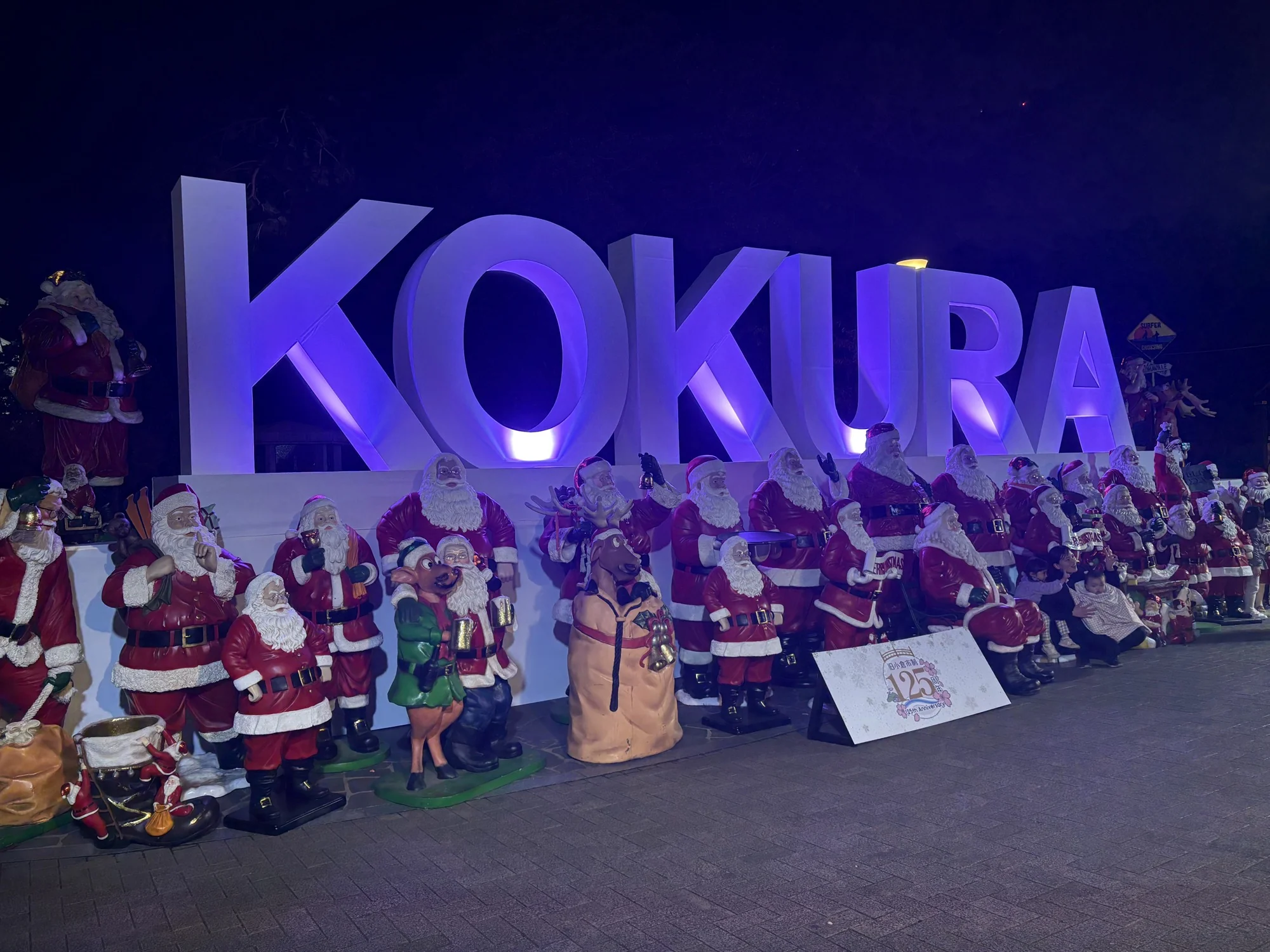 KOKURA の文字のモニュメントの前に並ぶサンタクロースの人形（2025年撮影）